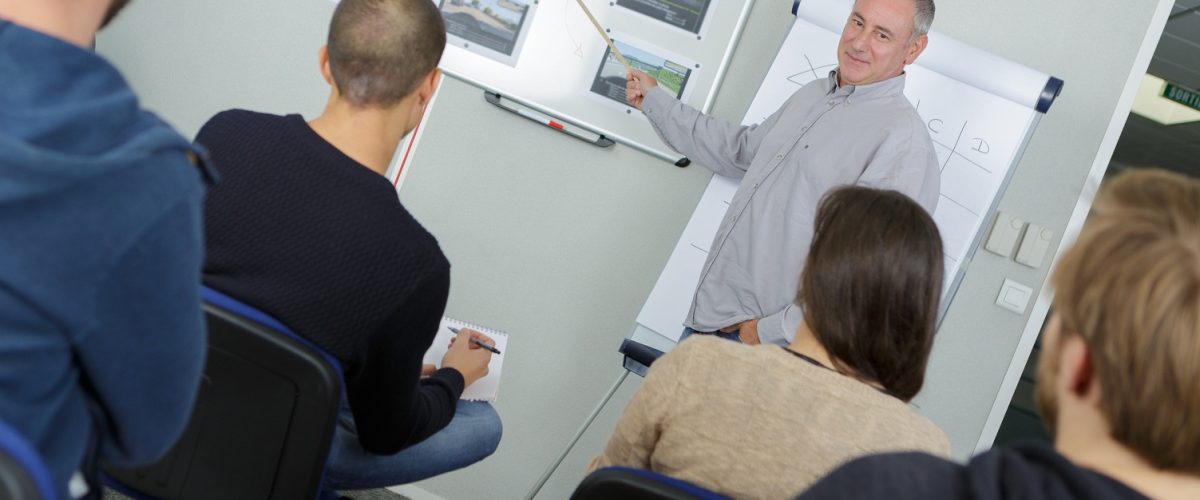Teacher stood in front of college class
